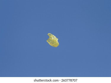 Yellow Plastic Shopping Bag Flying Through The Air