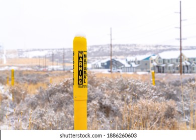 Yellow Pole With Warning Sign For Natural Gas Pipeline Buried Underground