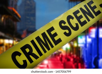 Yellow Police Crime Scene Tape With Night Time City Street In Background