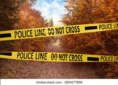 Yellow Police Tape Isolating Crime Scene. Restricted Area Of Autumn Park 