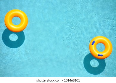 Yellow pool float, pool ring in cool blue refreshing blue pool, room for your text - Powered by Shutterstock