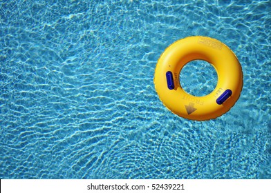 Yellow pool float/ring in pretty blue swimming pool
