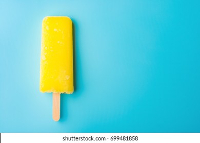 Yellow Popsicle On A Blue Background