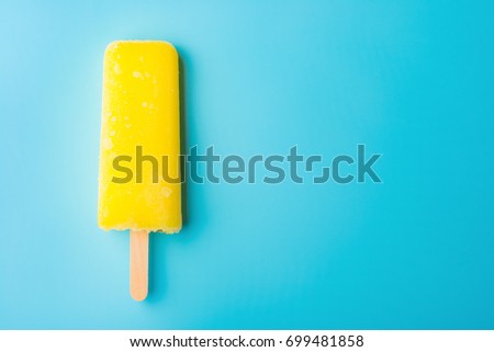 yellow popsicle on a blue background