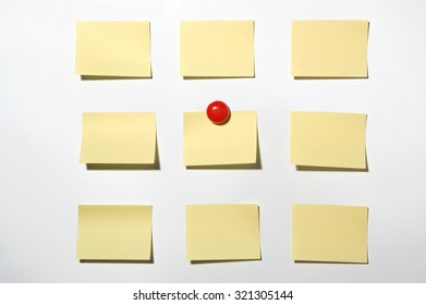 Yellow Post It Note And Magnet Button On Whiteboard