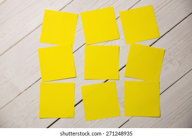 Yellow Post Its On Wooden Backround