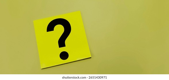 Yellow Post-It Note with Handwritten Question Mark Against Yellow Backdrop, Symbolizing Confusion, Thinking Process, or Decision Making in Modern Office Concept. 