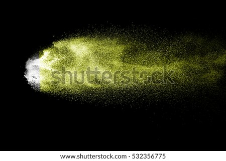 Yellow powder. Grainy abstract texture on black background.