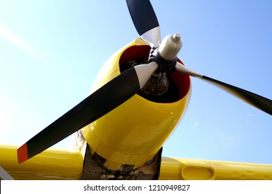 The yellow propellor of an old, historic aircraft