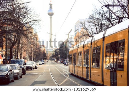 Yellow  public transportation tram passing by the city of Berlin Germany 