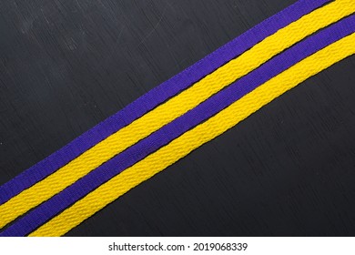 Yellow And Purple Shoelaces, Lakers Flag, On Black Wooden Background, Leaving Space For Advertising Text