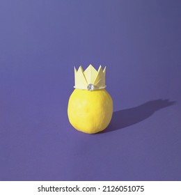 Yellow Quince Fruit With A Paper Crown Isolated On A Violet Background. Side View. Sharp Shadows. Minimal Concept.