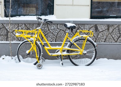 Yellow rack frame thick pack of snow on a single Dutch city bike with a  bicycle bag during a snowstorm in Zutphen, The Netherlands