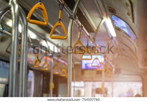 Yellow Rails for the passengers on the bus. low\
key and subject is\
blurred.