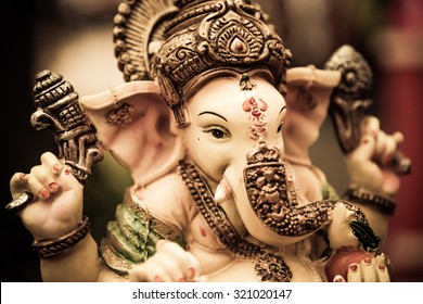 Yellow rasin Ganesh Elephant god statue  closeup focused on face  