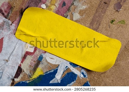 Yellow Rectangular Sticker on Dirty Street Wall Texture