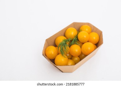 Yellow And Red Cherry Tomatoes In Crafty Eco-friendly Packaging. White Background. Minimalism. Cherry Tomatoes Isolated On White Background. Organic Cherry Tomatoes For Salad.