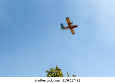 Yellow Red Firefighting Plane In Blue Sky