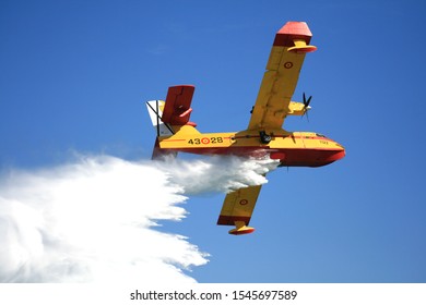 Yellow And Red Firefighting Plane Unloading Water