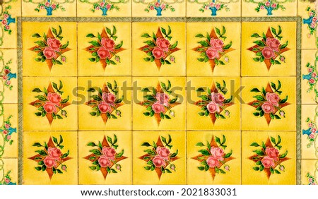 Yellow and red floral certamic tile mosaic, typical of those found on the facades of traditional Chinese Peranakan shop houses.
