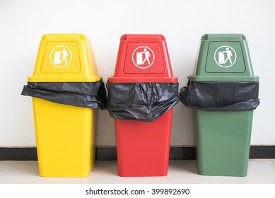 Yellow, Red And Green Recycle Bin On The Floor And White Wall