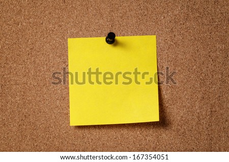 yellow reminder sticky note on cork board, empty space for text