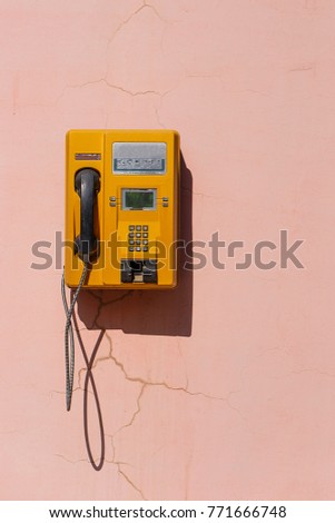 yellow retro telephone on pink wall, china