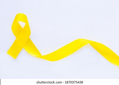 Yellow ribbon on white isolated background, copy space. Bone cancer, Sarcoma Awareness, childhood cancer awareness, cholangiocarcinoma, gallbladder cancer, world Suicide Prevention Day. Health concept