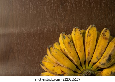 Yellow Ripe Banana On A Rattan Plate And Wooden Background