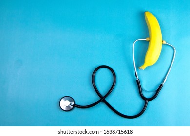 Yellow ripe banana with a stethoscope isolated on blue background. Healthcare And Medicine. Top views with clear space - Powered by Shutterstock