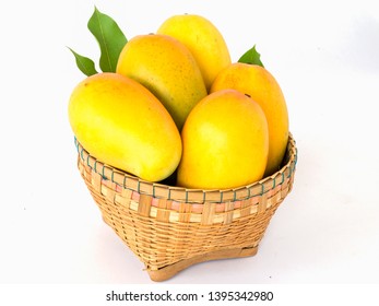 
Yellow ripe mango in a basket on a white background