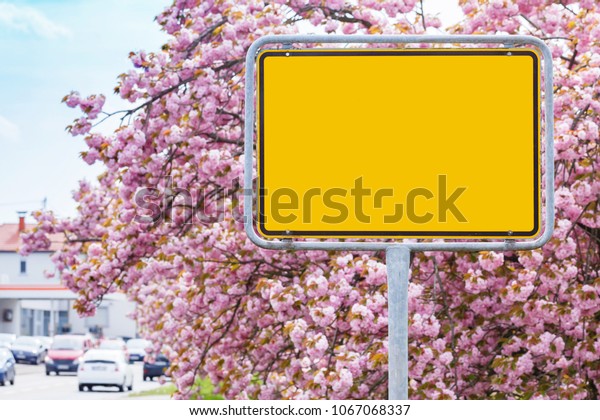 Yellow road empty sign on cherry blossoms background\
on german road