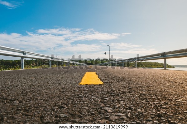 Yellow\
road line on the asphalt road to apart the lane for car driving, A\
moving forward road to success, new way\
concept