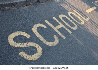 Yellow road marking "School" UK - Shutterstock ID 2315229825