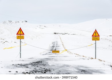 Yellow road signs on the closed road in winter, Iceland