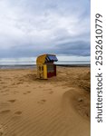 Yellow roofed wicker beach chair, beach on the North Sea, St. Peter-Ording, Schleswig-Holstein, Germany, Europe