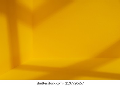 Yellow room corner with crossing windows shadows. Minimalistic space concept