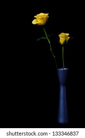 Yellow rose in silver vase on black background