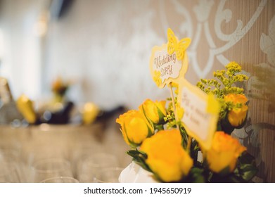 yellow roses at wedding table at restaurant - Shutterstock ID 1945650919