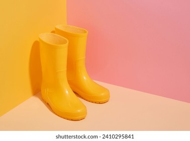 Yellow rubber boots for working in the garden or walking in the forest. Copy space for text.