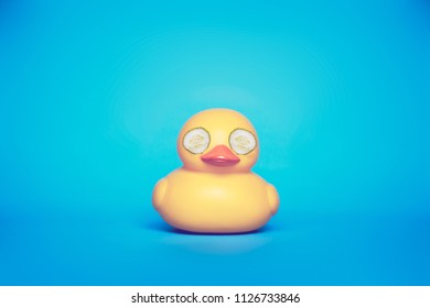 Yellow Rubber Duck With Cucumber Eye Mask On.