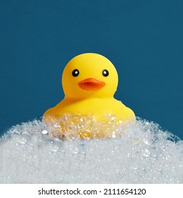 Yellow Rubber Duck Toy Floating On Soap Or Shampoo Bubble Foam In The Bath. Duckling In Bubble Bathtub With Soapy Foam.