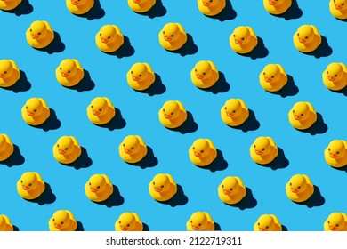 Yellow rubber duck toys pattern on seamless blue background. Bright conceptual banner design. - Shutterstock ID 2122719311