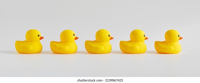 Yellow Rubber Ducks Arranged In A Row On White Background. 