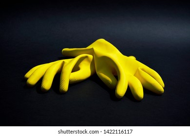 Yellow Rubber Gloves On Black Background