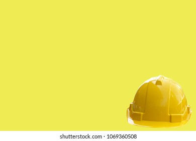 Yellow safety hat isolated on yellow background