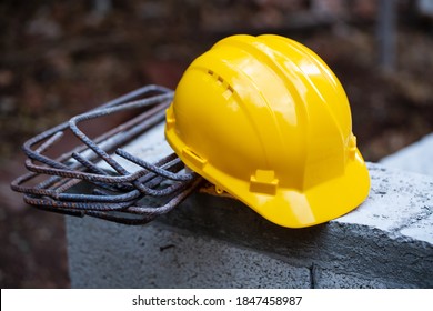 Yellow safety helmet, hard hat. Construction hard hat safety tools equipment for workers in construction site for engineering protection head standard on building construction background. 