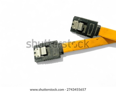 Yellow SATA data cable with black connectors and metal locking latches, used for connecting hard drives and SSDs to a computer motherboard, isolated on a white background.