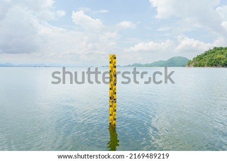 The yellow scale measures the height of the water in the dam. The water in the reservoir is plentiful and is used for agriculture and the village consumption.Reserving water nature in Thailand