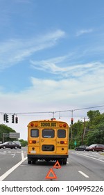 Yellow School Bus Broken Down On Blacktop Street At Traffic Light Back Window Sign No Sleeping Children